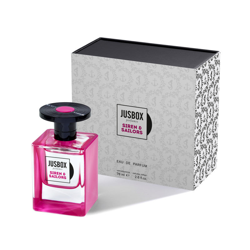 A bottle of Jusbox's Siren & Sailors Eau de Parfum sits next to its decorative box packaging, evoking the vibrant spirit of Camden Town.