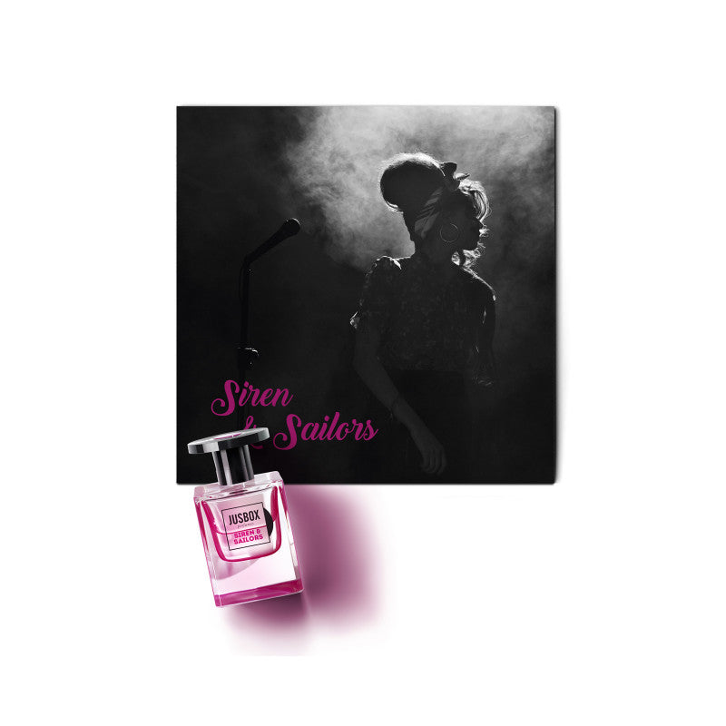 A silhouette of a woman with voluminous hair, reminiscent of Amy Winehouse, stands in front of a microphone behind a pink perfume bottle labeled "Siren & Sailors by Jusbox.