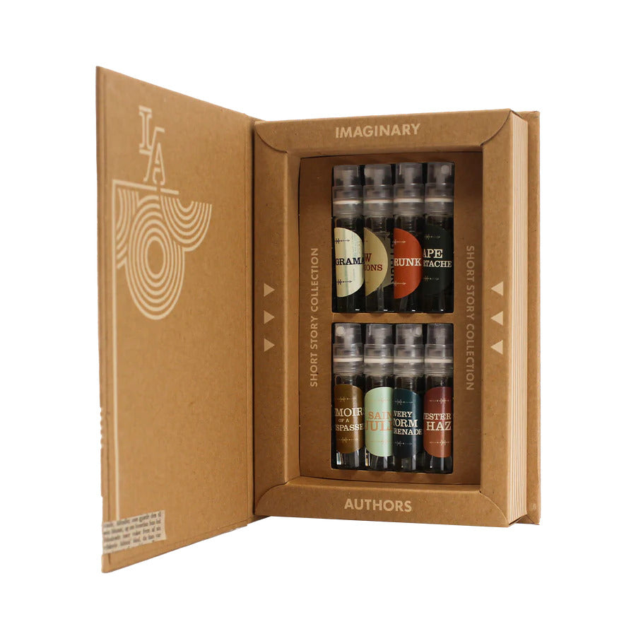 Open cardboard box displaying six small bottles labeled "Imaginary Authors Short Story Collection" fragrances from Imaginary Authors. The box has text on the inside and outside panels.