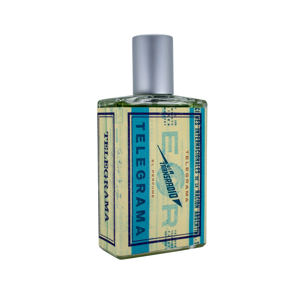 A bottle of perfume labeled "Telegrama" by Imaginary Authors with a blue and cream color scheme, a silver cap, and the plush scent reminiscent of a vintage first-class experience.