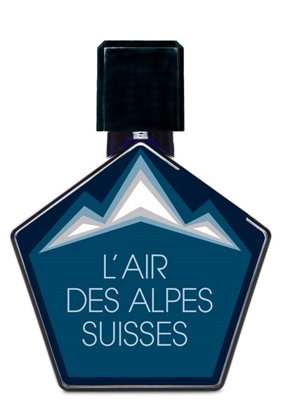 Hexagonal bottle with a dark cap, labeled "L'Air Des Alpes Suisses" by Tauer Perfumes in white text. The label features an illustration of Swiss mountains and highlights the scent's blend of alpine herbs.