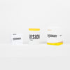 Three-piece candle set with white jars and box, yellow VISION/VISIONARY labels