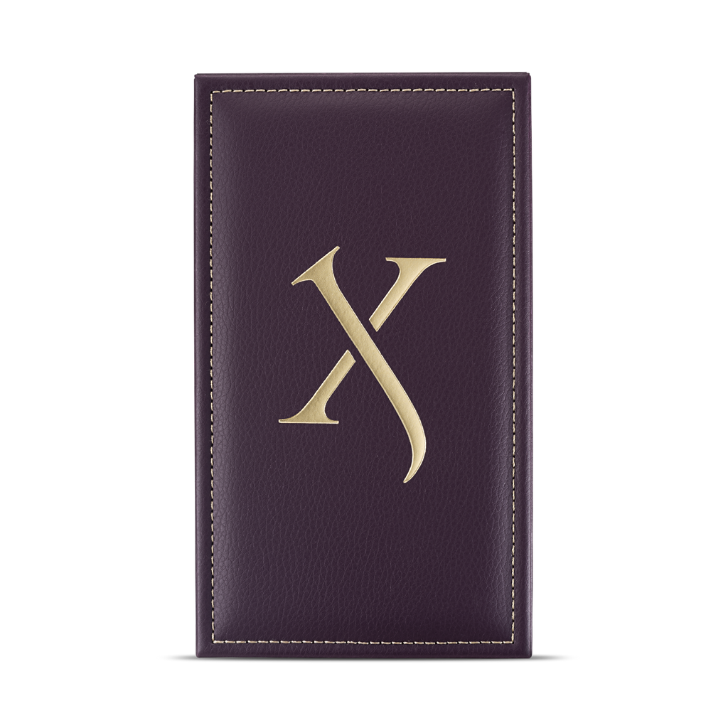 A purple leather cover with gold stitching and a large gold letter "X" in the center, reminiscent of the Xerjoff Alexandria Orientale collection and its luxurious oriental scent.
