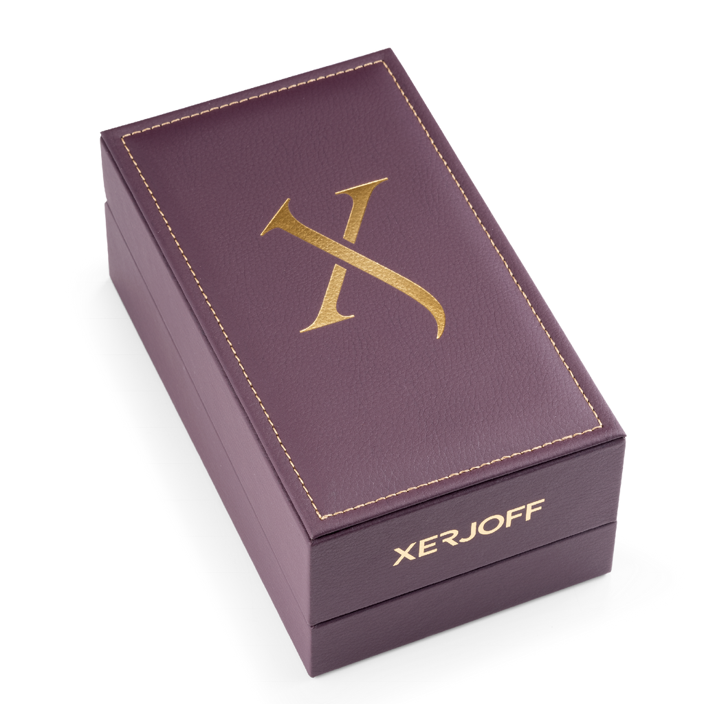 A purple leather box with gold lettering displaying the brand name "Xerjoff" and a large gold "X" on the lid, holding Alexandria Orientale, an oud perfume with an exquisite oriental scent.