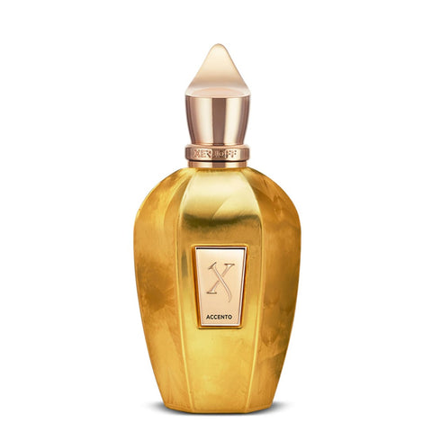 A golden perfume bottle with a pointed cap and a front label reading "Xerjoff Accento Overdose." The olfactory notes capture an intoxicating essence, reminiscent of the luxurious Accento Overdose.