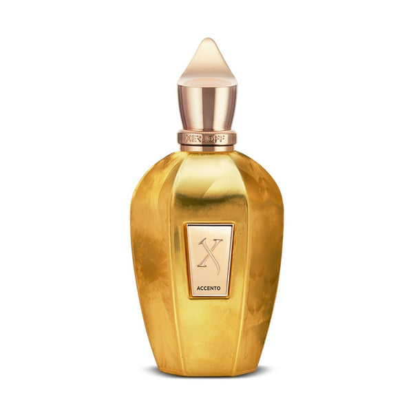 A golden perfume bottle with a pointed cap and a front label reading "Xerjoff Accento Overdose." The olfactory notes capture an intoxicating essence, reminiscent of the luxurious Accento Overdose.