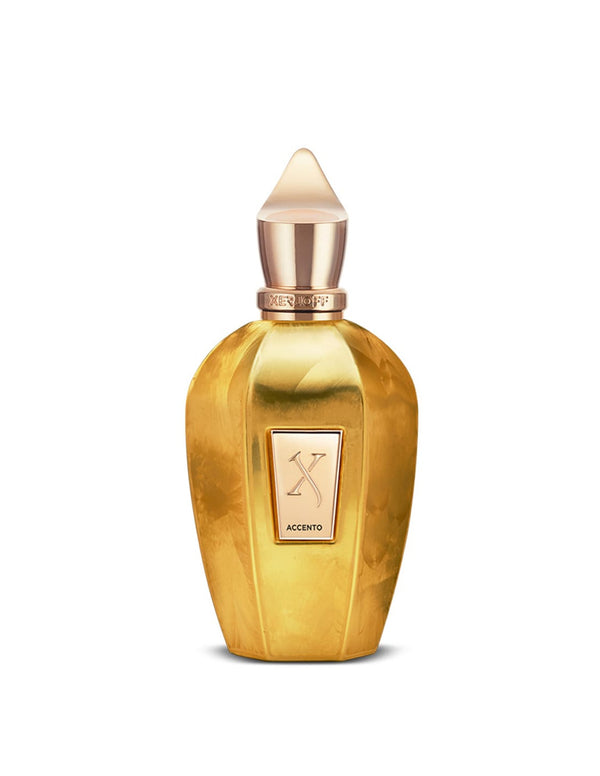 A golden perfume bottle with a pointed cap and a front label reading "Xerjoff Accento Overdose." The olfactory notes capture an intoxicating essence, reminiscent of the luxurious Accento Overdose.