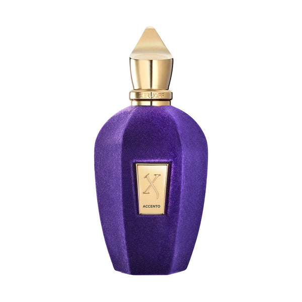 A purple and gold perfume bottle labeled "Accento" by Xerjoff boasts a gold cap and a geometric design, epitomizing pure luxury with its fruity scent.