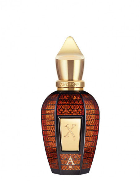A decorative, dark-colored perfume bottle with intricate gold and red patterns, featuring a gold cap and a gold label with the letter 'X' on its front. The scent inside hints at the luxurious richness of Bulgarian Rose. The perfume is Alexandria III by Xerjoff.