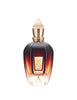 A dark amber glass perfume bottle with a gold-toned cap and label, featuring the text "Alexandria II" and a letter "X" at the bottom, evokes an aura as rich as its scent with subtle hints of Laotian oud.