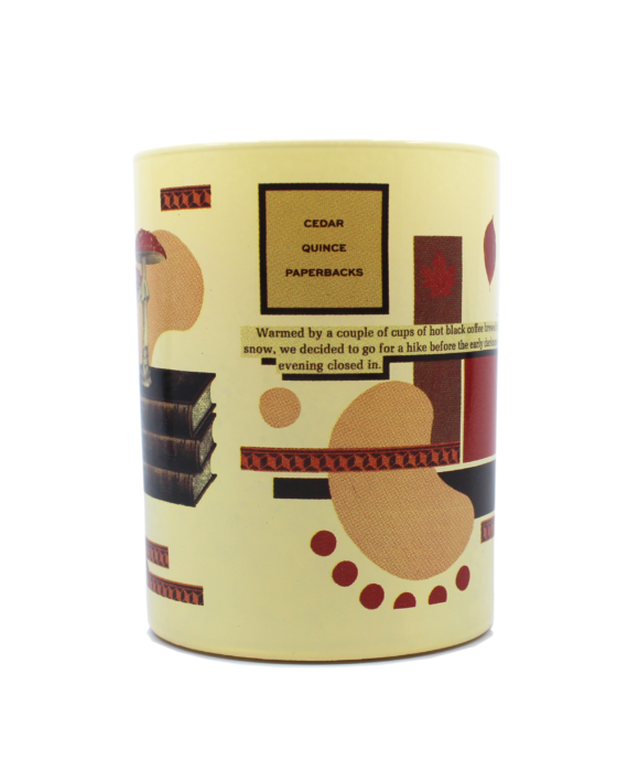 The Abandoned Mansion by Imaginary Authors is a beige cylindrical container featuring abstract art with text about hiking and books, incorporating the words "CEDAR," "QUINCE," and "PAPERBACKS." The design elegantly blends books and geometric shapes.