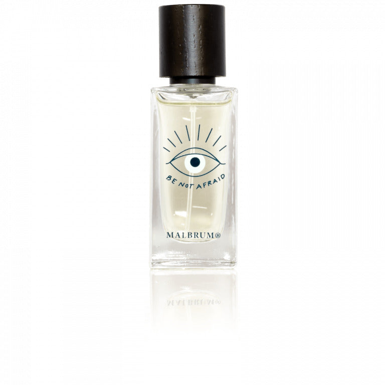 A bottle of Bagheera perfume with a black cap labeled "Be Not Afraid" and featuring an eye illustration on the bottle's front. The brand name, "Malbrum Parfums," is written below the illustration, evoking a sense of mystery with its undertone of dark powdery iris.