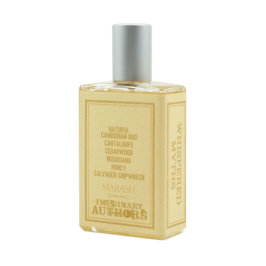 A bottle of Imaginary Authors labeled "Whispered Myths" featuring notes such as natural Cambodian Oud, cantaloupe, cedarwood, musk, honey, and salvaged shipwreck.