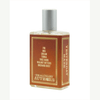 A bottle of Yesterday Haze perfume by Imaginary Authors. The label lists notes: fig, iris, cream, tonka, tree bark, walnut bitters, orchard dust. This seductive scent comes in a rectangular bottle with a metallic cap.
