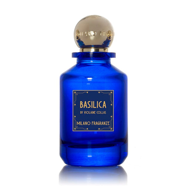 A blue glass bottle of Basilica by Milano Fragranze, with a gold cap and a gold-accented label, exuding scents reminiscent of soothing incense.