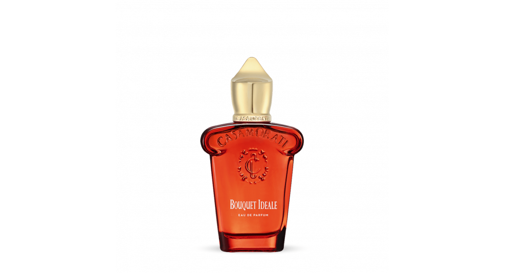 A red perfume bottle with a gold cap, labeled "Casamorati" and "Bouquet Ideale," embodies the luxurious allure of Italian perfumery with its spicy oriental fragrance.