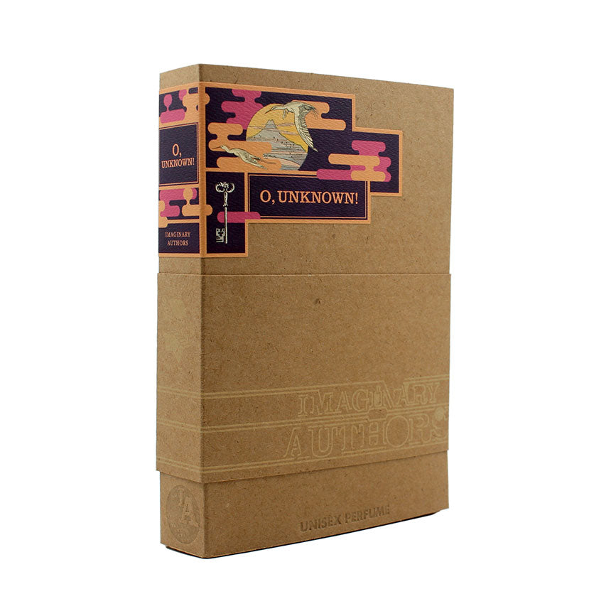 Introducing "O, Unknown!" by Imaginary Authors, a book-shaped box adorned with a colorful illustration on the spine. The brown box features a band around the middle labeled "UNISEX PERFUME," containing a mysterious scent that combines Musk Balsam and Sandalwood, with subtle notes of Black Tea.