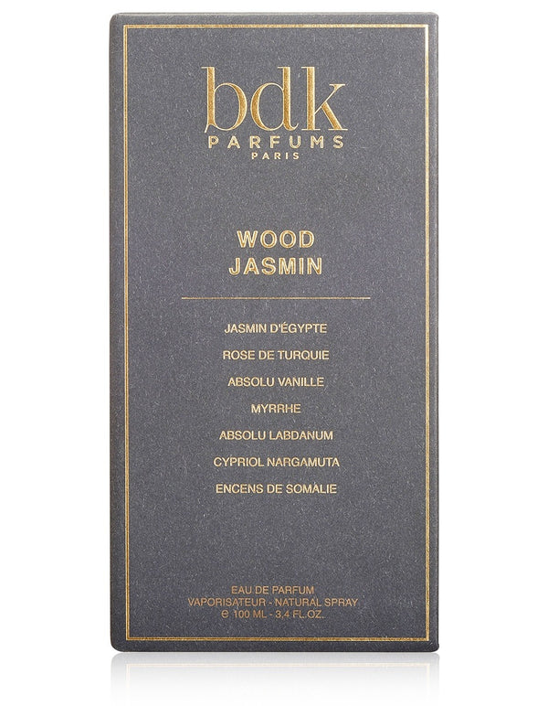 Black box of Wood Jasmin Eau de Parfum by BDK Parfums. The box lists its ingredients: Jasmine d'Egypte, Rose de Turquie, Absolu Vanille, Myrrhe, Absolu Labdanum, and more. This precious elixir evokes the essence of mysterious woods.