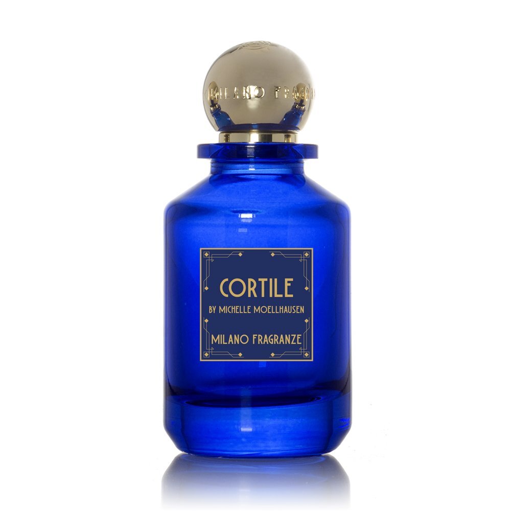 A blue glass bottle of "Cortile" Eau de Parfum by Milano Fragranze, featuring a round silver cap and gold label text. The fragrance offers hints of jasmine and fresh coffee aromas.