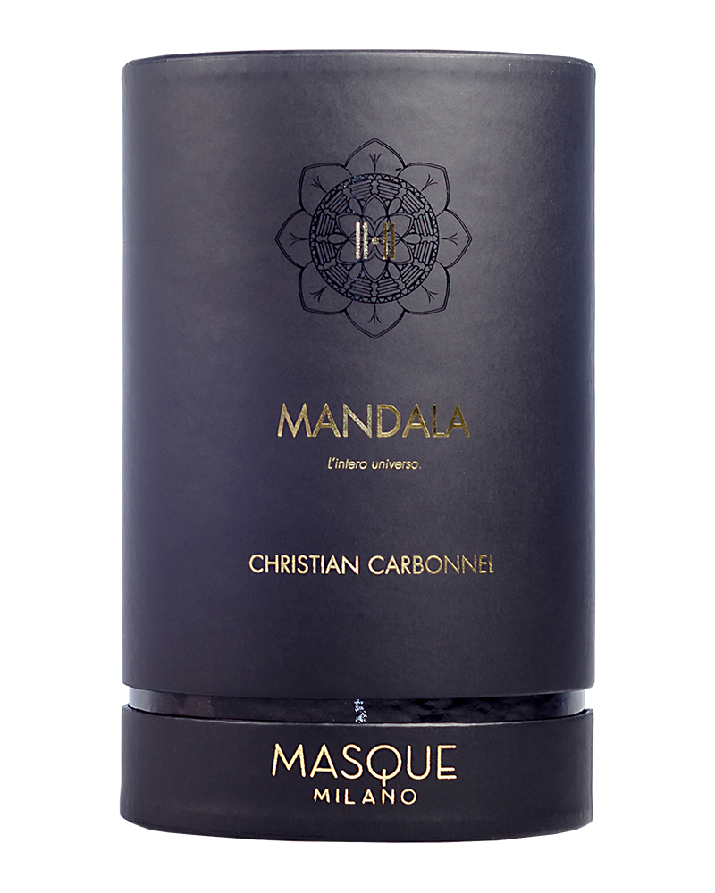 The dark cylindrical container features gold and white text, adorned with a geometric design that highlights "Mandala," "Christian Carbonnel Perfumeur," and the brand name "Masque Milano." Its scent is a captivating and timeless blend of myrrh and incense.