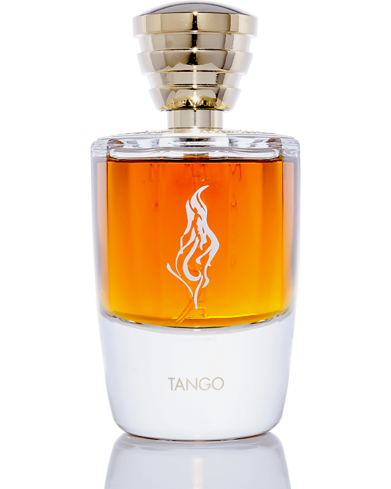 A bottle of Masque Milano's Tango perfume features amber nectar liquid, a gold cap, and a flame logo etched onto its transparent glass bottle. The base is white with "TANGO" elegantly written in gold letters. This sensual fragrance promises to captivate with its alluring presence.
