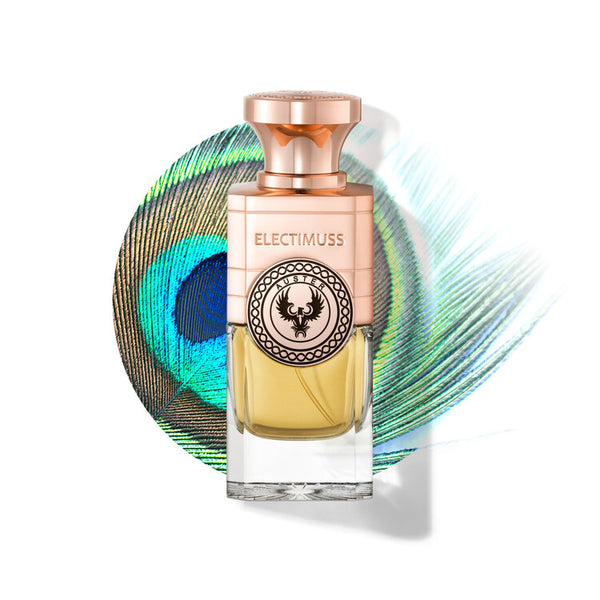 A bottle of Electimuss Auster perfume with a gold cap and ornate label stands in front of a peacock feather background, exuding a spicy fruity floral essence layered over an earthy woody base.