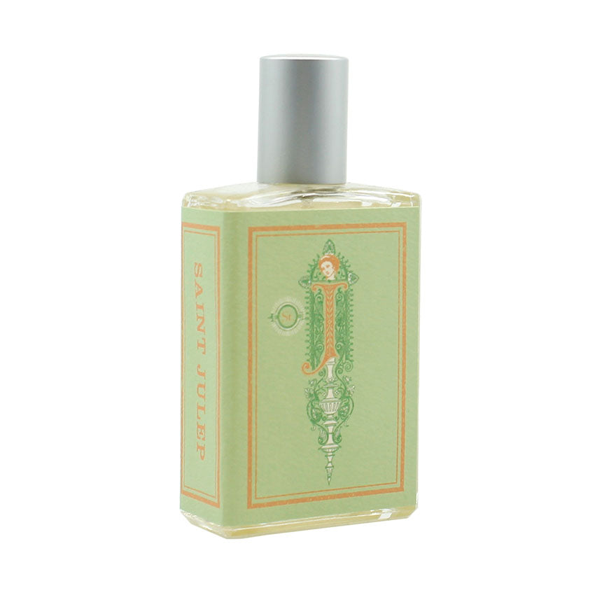 The rectangular perfume bottle by Imaginary Authors features a silver cap and a light green label, adorned with the words "Saint Julep" in orange letters on the side, suggesting sweet mint undertones.