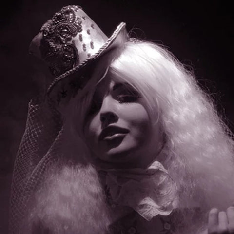 White faux-fur wrap with dark sequined headpiece and feathered trim