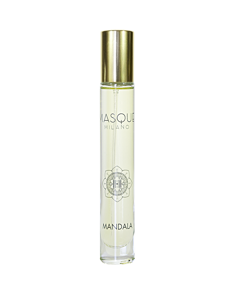 A clear cylindrical bottle with a gold cap, labeled "Mandala" by Masque Milano, containing a light-colored liquid infused with the myrrh and incense fragrance crafted by Christian Carbonnel Perfumeur.