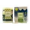 The "Meet Me In The Meadow" candle from Imaginary Authors is positioned next to its matching box. This candle boasts a soy blend scent of grapefruit, linden, and pinot gris. Two green-tipped matches lie in front of it, and it offers a 60-hour burn time.