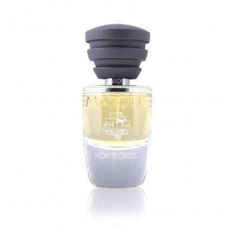 A clear bottle of Montecristo perfume by Masque Milano, featuring a black ridged cap and light yellow liquid inside, is elegantly designed with a gray lower half that displays the brand's logo and name. This fragrance exudes notes reminiscent of rich tobacco leaves.