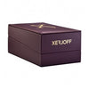 A closed, rectangular, dark purple box featuring "Xerjoff" printed in gold lettering on the side and a gold emblem on the lid hints at the luxurious "More Than Words" oud fragrance within.
