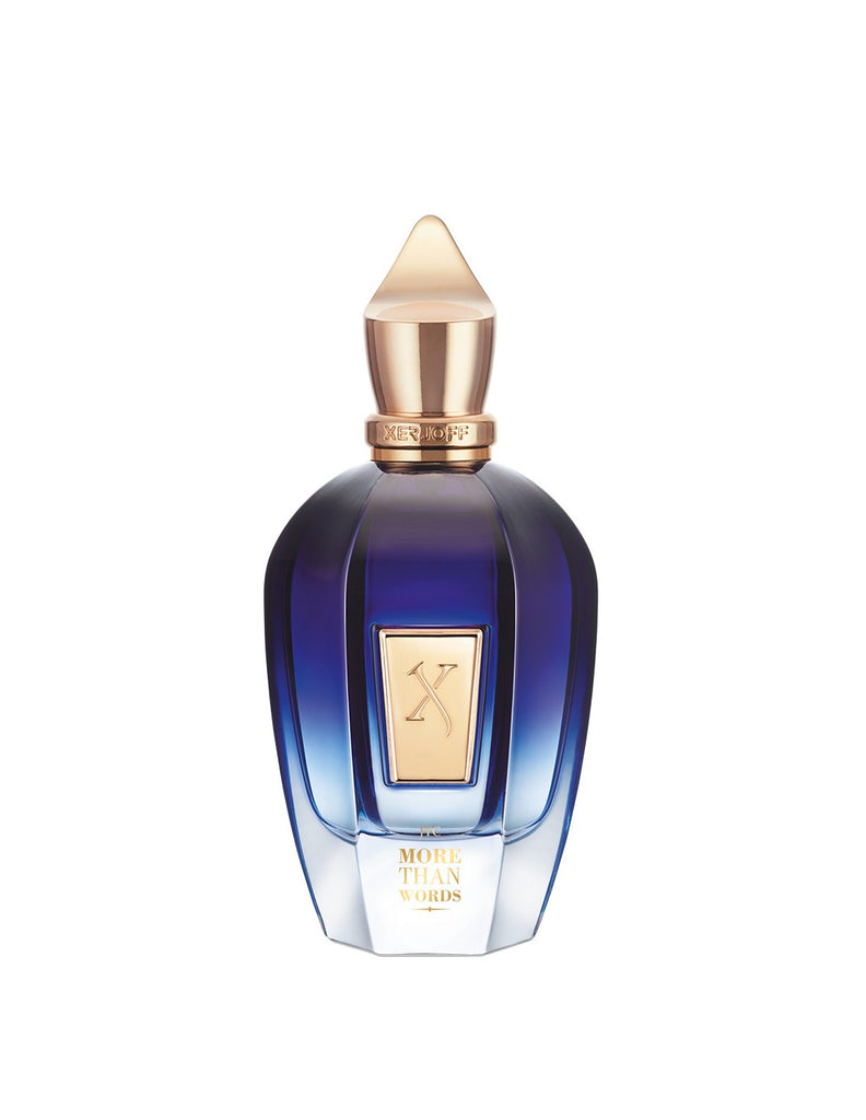 A blue and gold perfume bottle labeled "More Than Words" by Xerjoff, adorned with a geometric gold cap and an elegant gold label featuring an ornate "X" design. This sophisticated bottle houses a fragrance enveloped in oriental woods and oud notes.