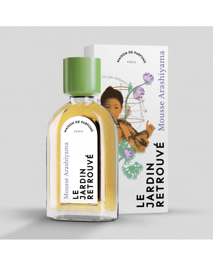 A bottle of Mousse Arashiyama by Le Jardin Retrouvé rests in front of its illustrated box, adorned with a traditional Japanese image and floral elements, evoking the serene atmosphere of a Japanese bamboo grove with hints of incense and sacred woods.