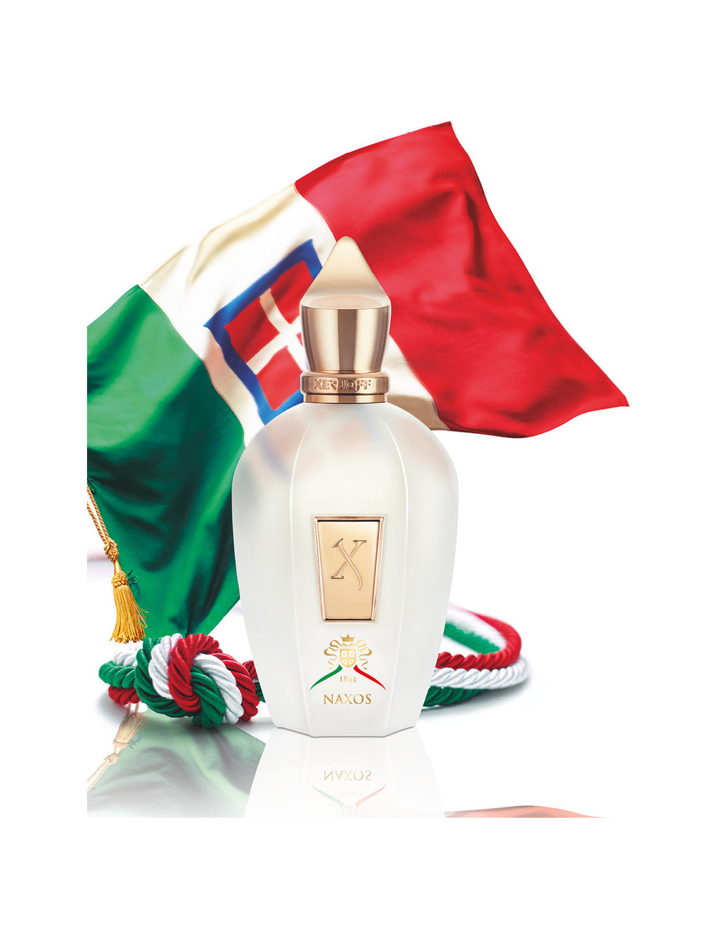 A bottle of Naxos by Xerjoff stands before the Italian flag, with a tricolor rope lying beside it, evoking the vibrant essence of Sicily and the refreshing zest of Mediterranean citruses.