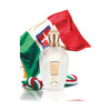 A bottle of Naxos by Xerjoff stands before the Italian flag, with a tricolor rope lying beside it, evoking the vibrant essence of Sicily and the refreshing zest of Mediterranean citruses.