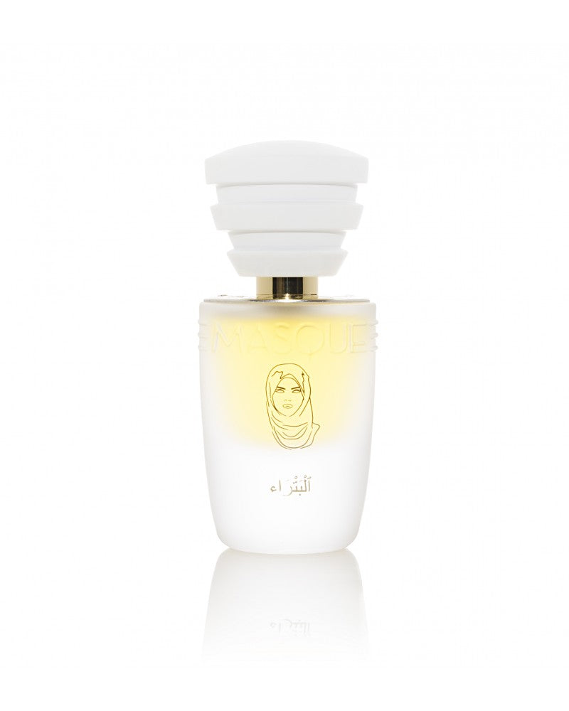Petra by Masque Milano is a white bottle of perfume adorned with a golden illustration of a woman in a headscarf. Celebrating the brand's 10th anniversary, this limited edition features a distinctive white cap with stacked elements and is hand-numbered, delivering an exquisite blend of incense and patchouli.