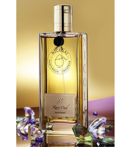 Rose Oud eau de parfum bottle with gold cap, amber glass