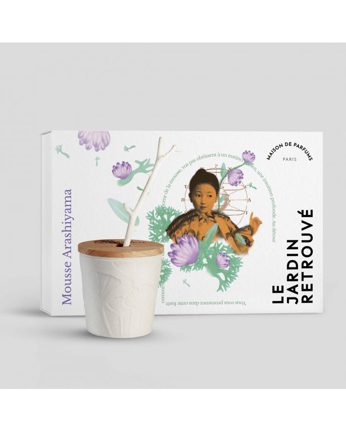 A cup holding a plant branch and a box with a floral design, labeled "Mousse Arashiyama" from Le Jardin Retrouvé, Maison de Parfum, Paris. This ensemble evokes the elegance of Limoges porcelain and pairs perfectly with the Mousse Arashiyama Scented Stem Diffuser.