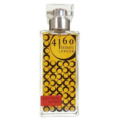 Clear perfume bottle with metallic silver cap and gold circular label