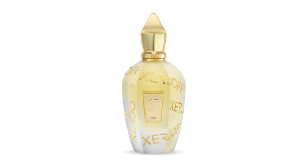 An exclusive luxury perfume bottle, featuring a gold cap and gold lettering reading "Xerjoff" on a gradient white and yellow body, part of the Sketchbook Collection, exudes an aura of floral and fruity elegance. This exquisite creation is named Sketchbook P. 33 by Xerjoff.