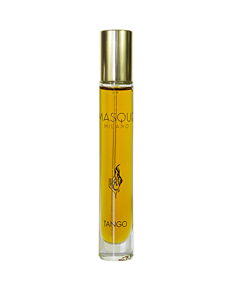 A bottle of Masque Milano Tango perfume, capped in gold and filled with amber nectar, stands upright against a white background.