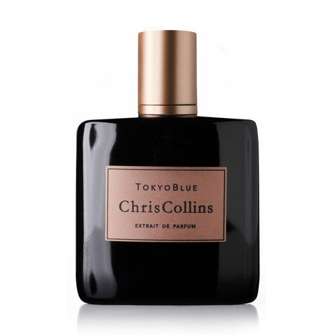 A bottle of Tokyo Blue by Chris Collins, featuring a black exterior with a gold label, exudes a masculine floral fragrance and is part of the Dark Romance Collection.