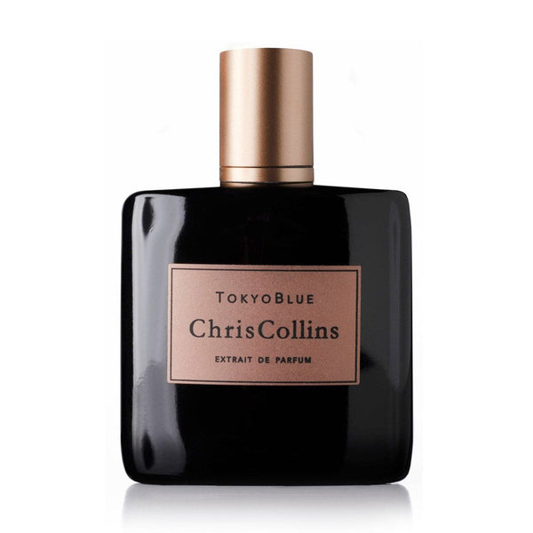 A bottle of Tokyo Blue by Chris Collins, featuring a black exterior with a gold label, exudes a masculine floral fragrance and is part of the Dark Romance Collection.