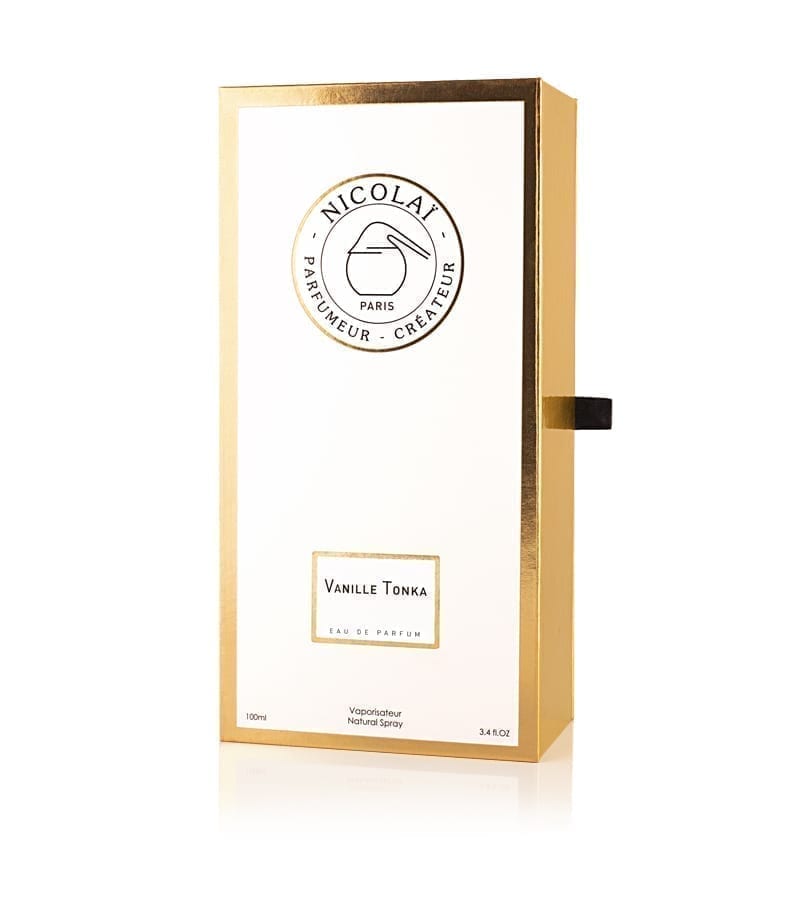 A rectangular white and gold perfume box labeled "Nicolaï Parfumeur-Createur Paris" with "Vanille Tonka" text, containing 100ml of eau de parfum infused with subtle hints of orange blossom.